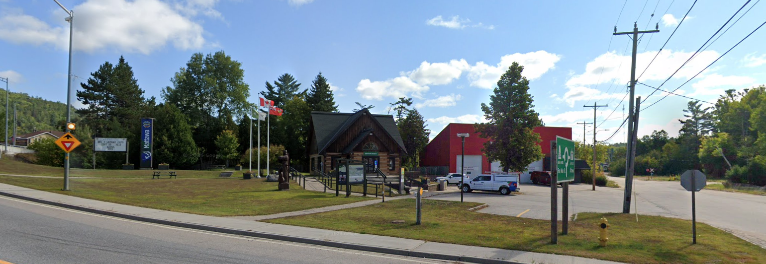 log cabin building alongside road